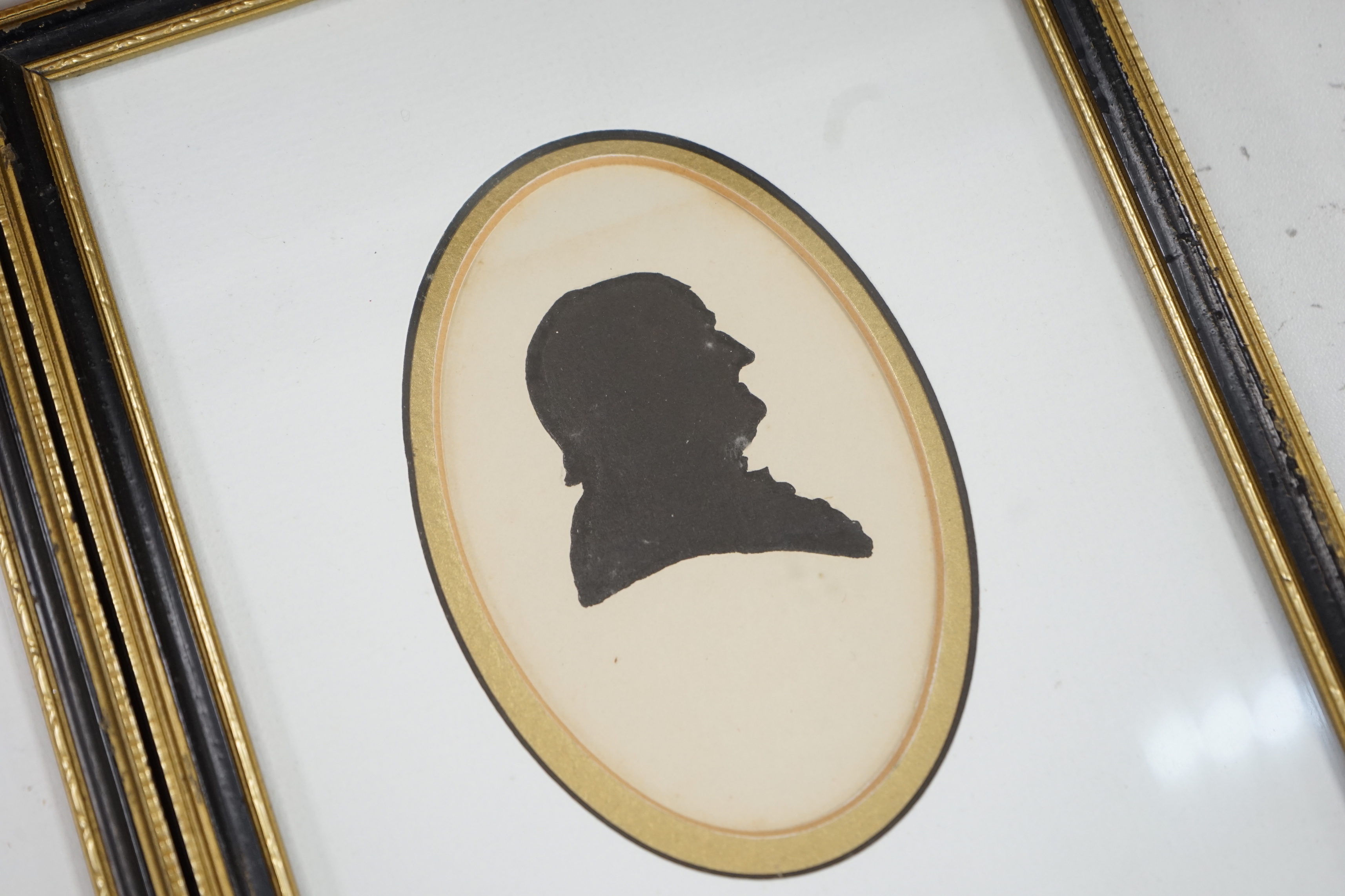 A pair of Georgian oval painted silhouette portraits, lady and gentleman, 10 x 6.5cm